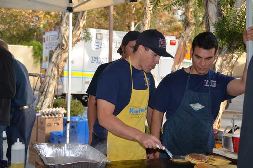 Curtis and Tony flipping cakes under Jeffs watchful eye